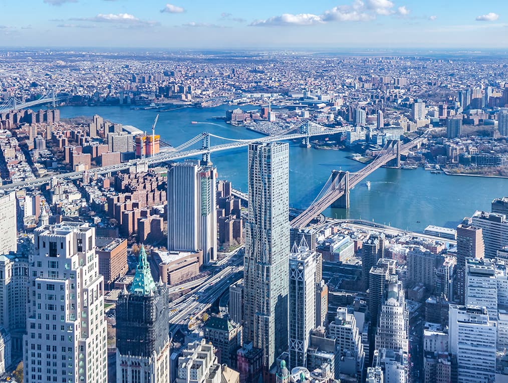 Aerial shot of a downtown with bridges and crossing river.